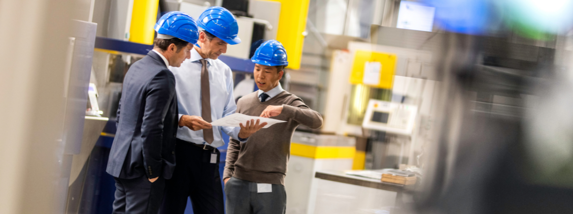 Three workers reviewing the workplace Health and Safety Policy