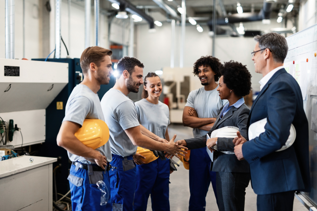 Workers and JHSC Members are shaking hands after a safety meeting in Ontario, Canada